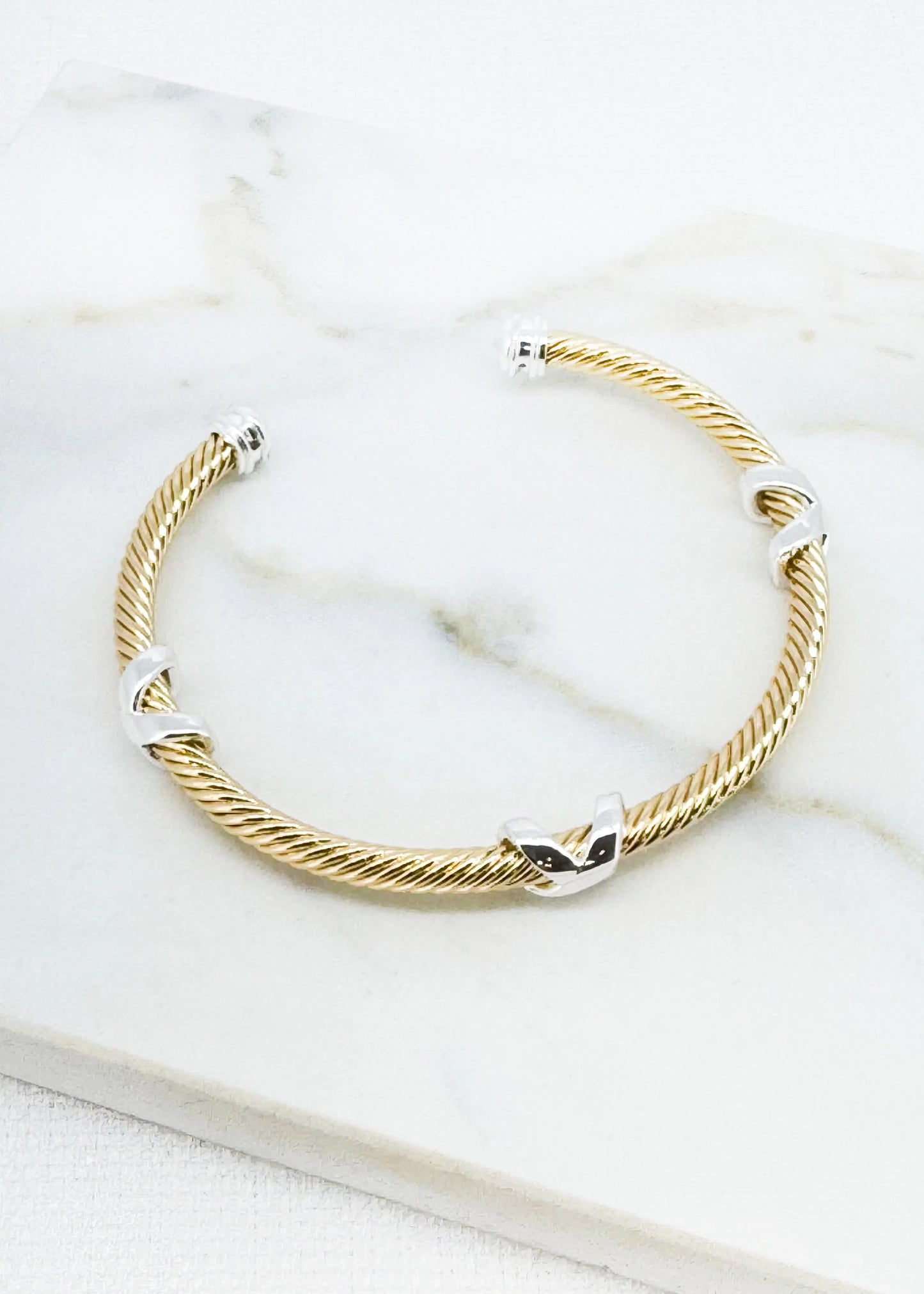Textured silver and gold two tone bangle with kiss design